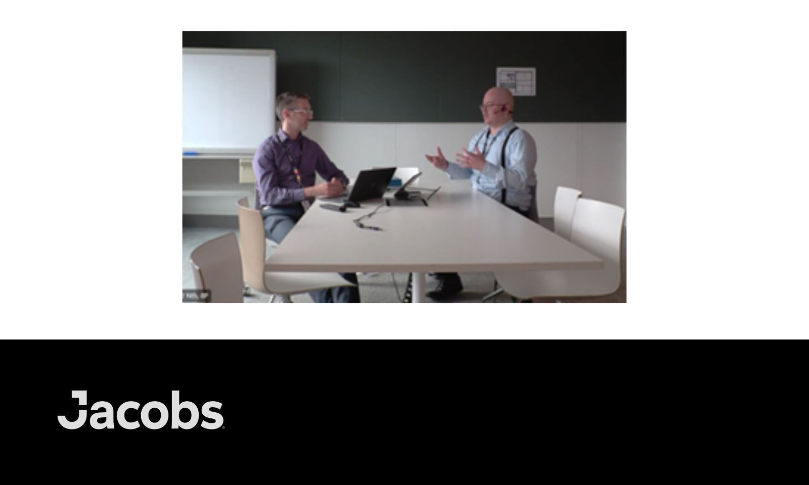  Two men sitting face to face at a table